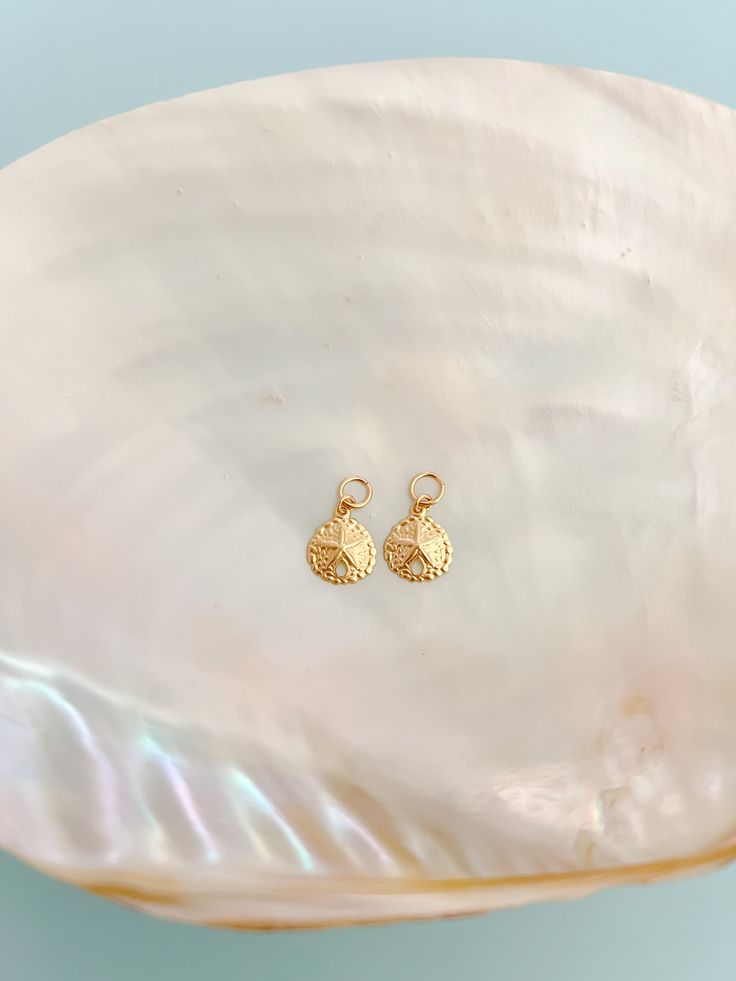 One set of 14k Gold Filled Sand Dollar Earring Charms! This listing is just for a set of charms! Sand Dollar Charms are around 0.35". Mix & match your earrings by switching out your charms with the other options we have! Link to buy the hoops you will put the charms on: https://shopmermaidandme.com/products/goldie-hoops What you need: 1 pair of our Goldie Hoops, and 1 set of our Earring Charms to get started! How to put your charms on your hoops: Open the earring & slide charm over the earring h Sand Dollar Earrings, Earrings Charms, Earring Charms, Sand Dollar, Gold Filled Jewelry, One Set, Hair Claw, Charm Earrings, Mix Match