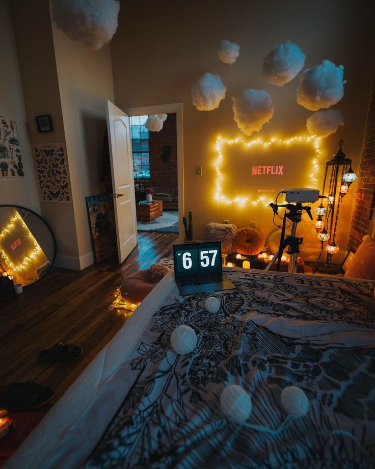 a bed room with a neatly made bed and decorations on the wall above it at night