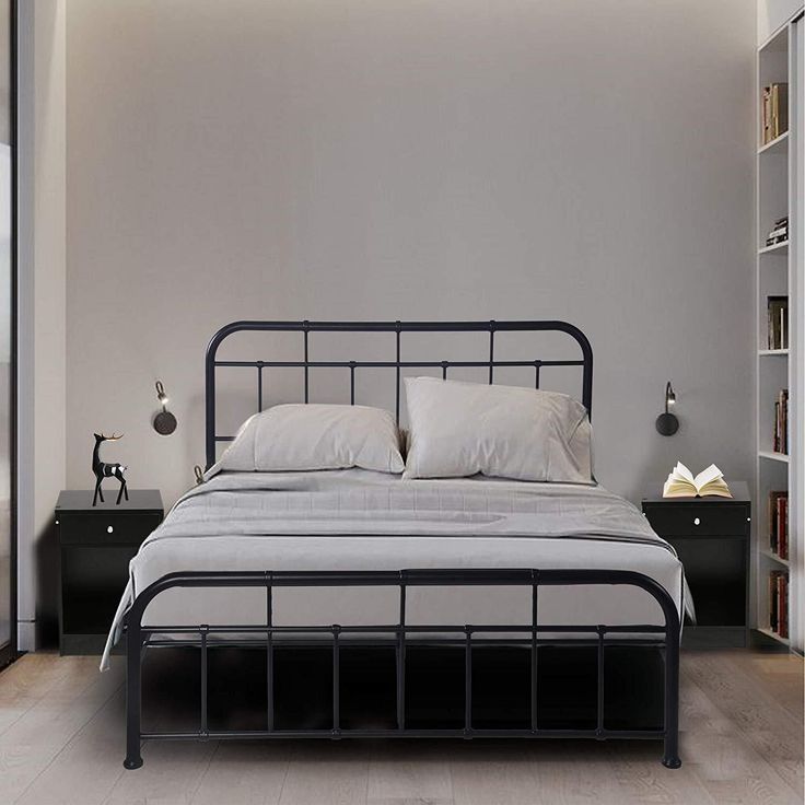 a bedroom with a bed, bookcases and bookshelves on the wall