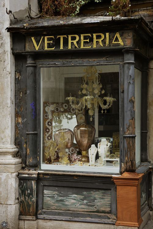 an old store front with vases in the window