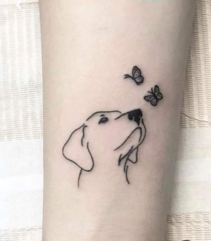 a dog and butterfly tattoo on the arm