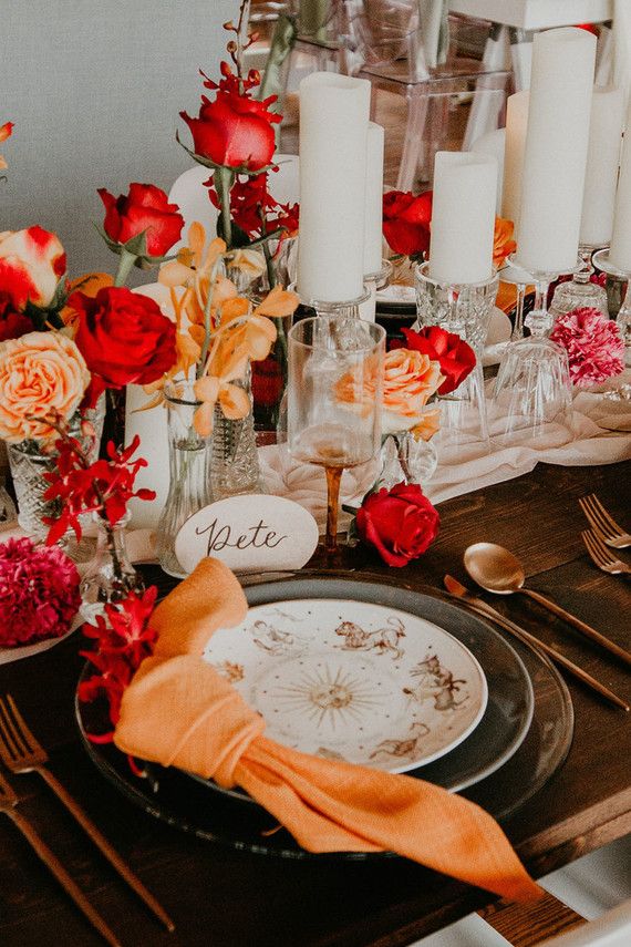 the table is set with flowers and candles