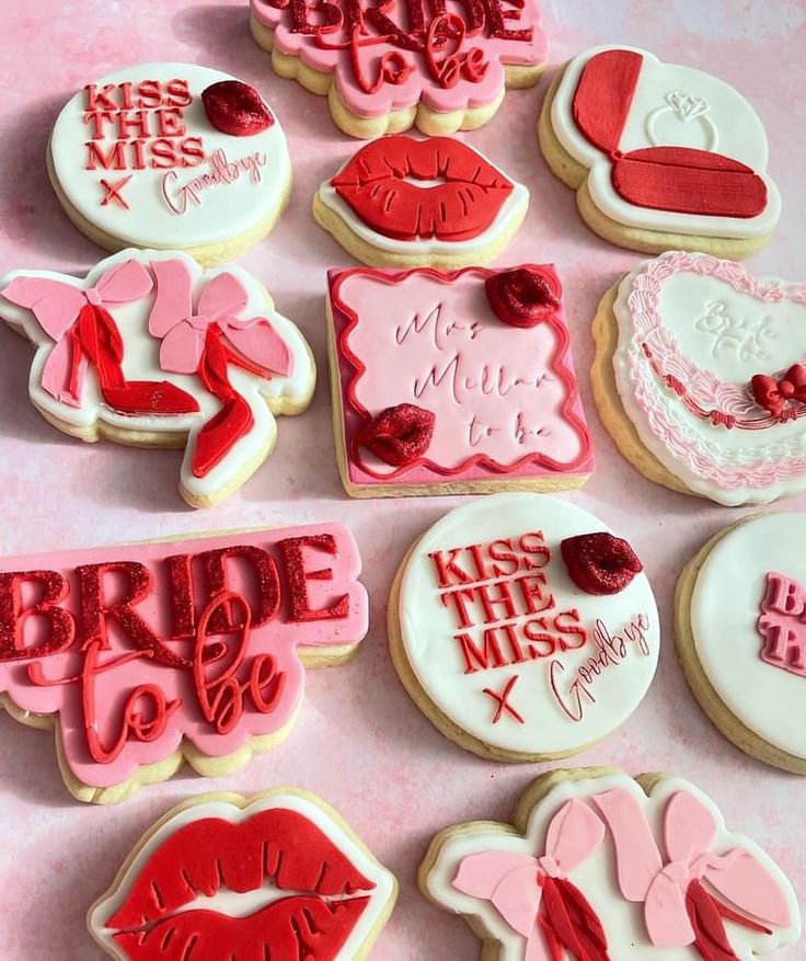 decorated cookies with red and white frosting are arranged in the shape of kisses, kiss me