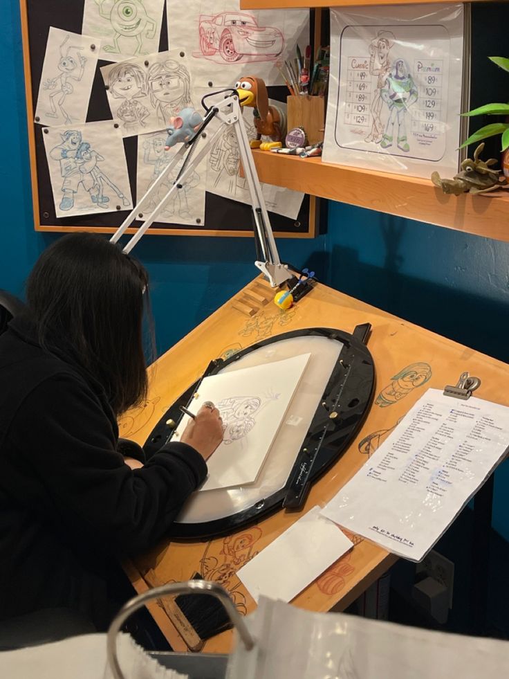 a woman sitting at a desk writing on paper