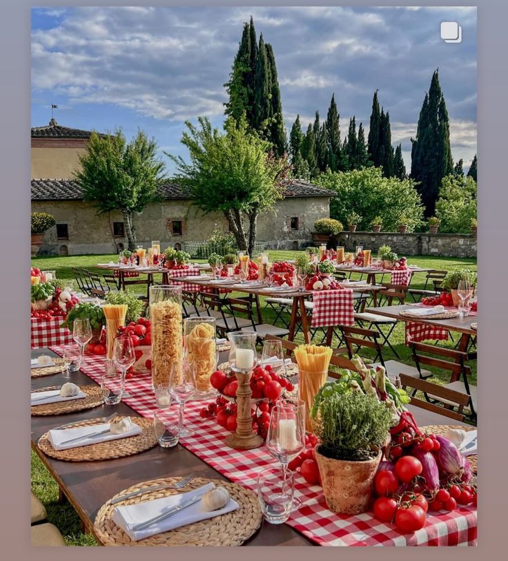 an outdoor dining area with tables and chairs covered in red checkered tablecloths