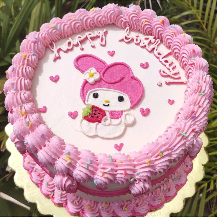 a hello kitty birthday cake with pink frosting and sprinkles