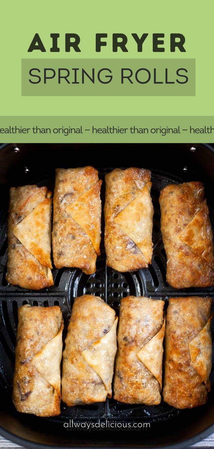 air fryer spring rolls in an air fryer with text overlay that says air fryer spring rolls