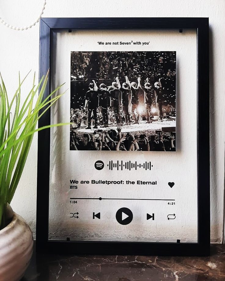 there is a black and white photo on the wall next to a potted plant