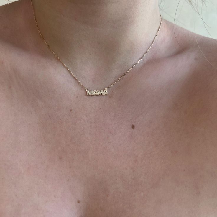 Treat yourself to a sparkly surprise! With Diamond MAMA Necklace you can show off your maternal pride with a dazzling diamond pendant draped around your neck. This timeless piece is sure to be a show stopper! 14k Yellow Gold | 14k White Gold | 14k Rose Gold | Sterling Silver Pendant: 20 x 6 mm 1/10 CTW l1 clarity natural diamond Adjustable 16" | 18" chain Mother's Day 14k Gold Name Necklace With Delicate Chain, Dainty Heart-shaped Name Necklace For Mom, Rose Gold Custom Name Charm Necklace For Mom, Rose Gold Name Charm Necklaces For Mom, Mother's Day Gold Diamond Name Necklace, Mama Necklace, Diamond Pendant, Timeless Pieces, Sterling Silver Pendants