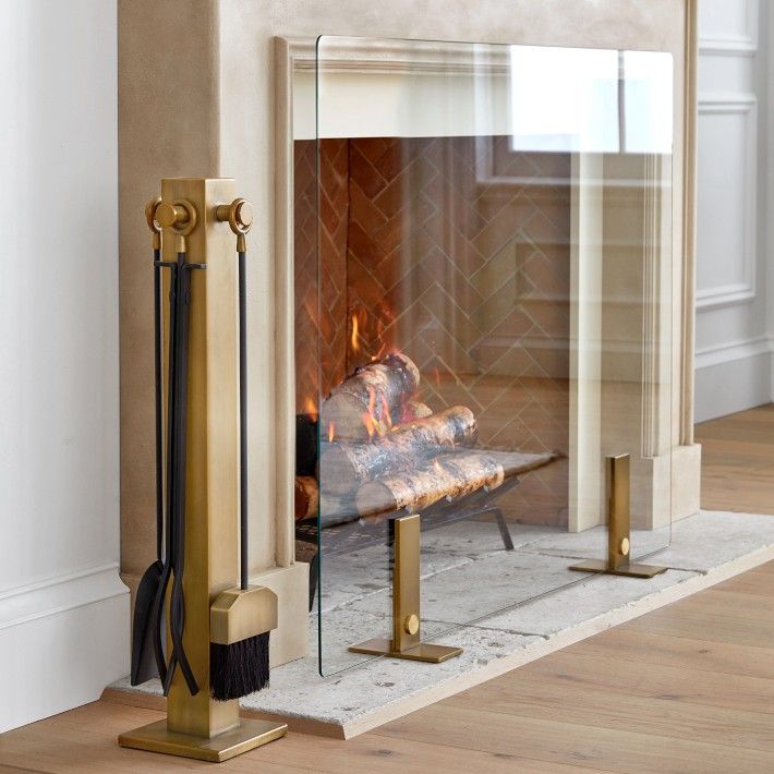 a fireplace with a fire in it next to a mirror