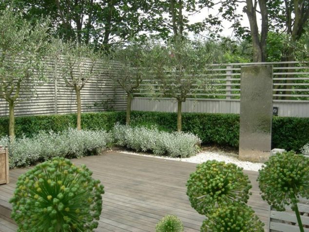 a wooden bench sitting in the middle of a garden