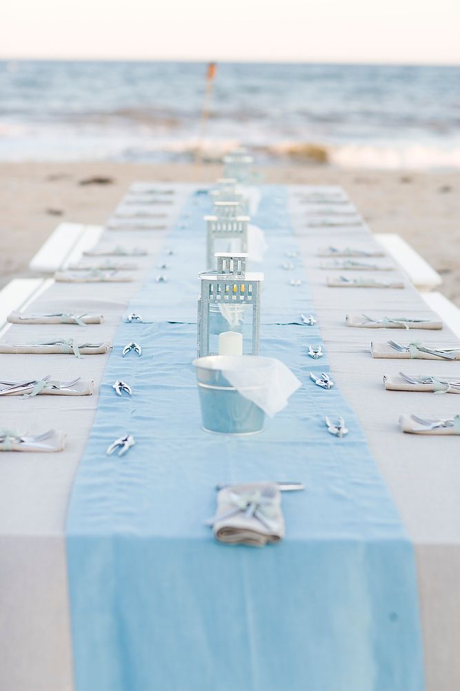 a long table is set up on the beach