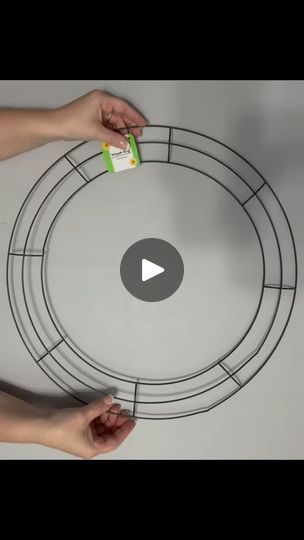 two hands are painting a circle with white paint