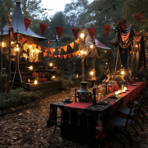 a long table with candles on it in the middle of a wooded area at night