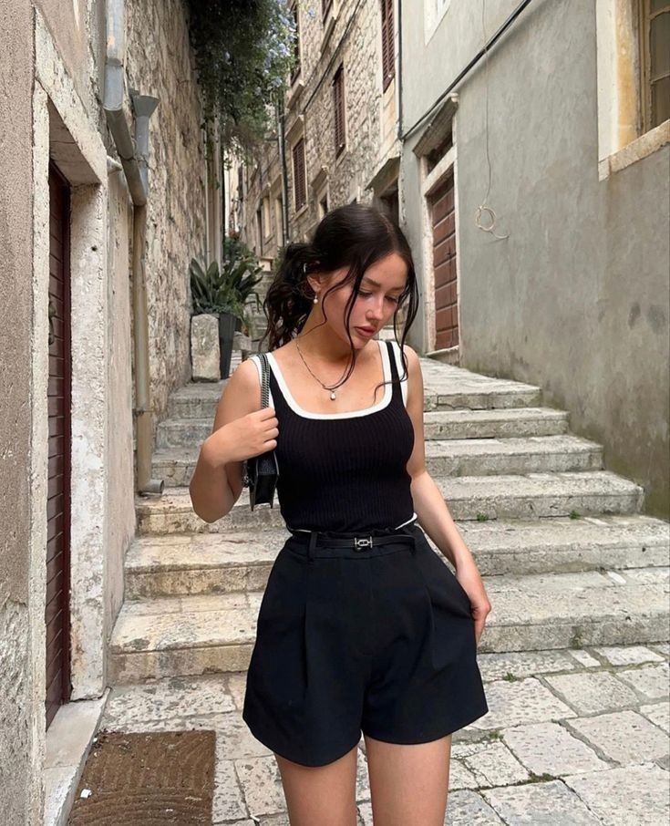 a woman in black shorts walking down some steps