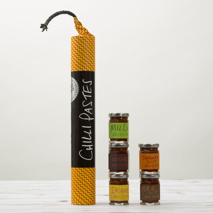 the chili sauce tube is next to four small jars