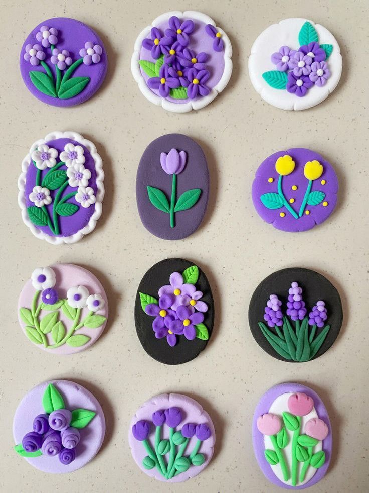 nine decorated cookies with flowers and leaves on them