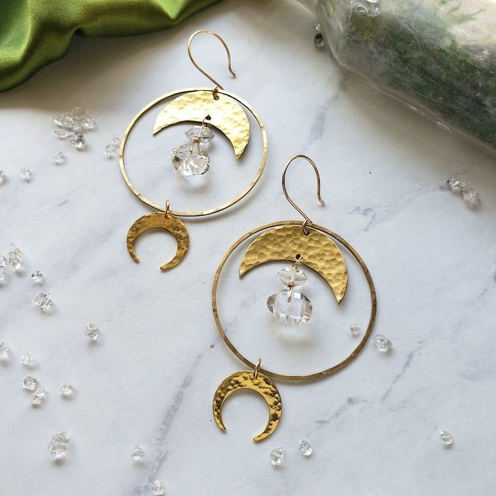 Hammered brass hoops and Moons featuring delicate Diamond Quartz Beads Simple and solid enough for daily wear 2" diameter. 3" long Each stone is unique and may vary slightly in color/shape from stone to stone. One of a kind handle with care Made with love by Elizabeth Cline in San Francisco, CA Wrapped in Dreamers of Dreams travel/gift bag Gold Hoop Jewelry With Moon Phase Detail, Handmade Moon-shaped Metal Hoop Earrings, Brass Hoop Earrings With Moon Charm As A Gift, Handmade Celestial Style Round Hoop Earrings, Bohemian Gold Hoop Earrings With Moon Charm, Bohemian Moon Phase Jewelry For Everyday, Bohemian Moon Shaped Brass Jewelry, Everyday Bohemian Moon Phase Jewelry, Everyday Brass Jewelry With Moon Charm