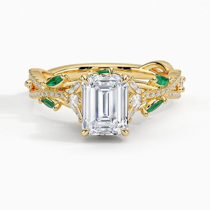 a rose gold engagement ring set with an emerald center stone and two side stones on the band