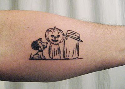 a person with a tattoo on their arm holding a cup and a dog next to it