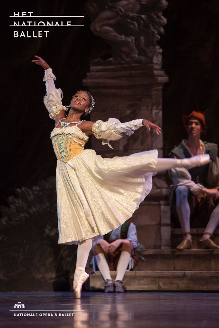 a woman in a white dress dancing on stage