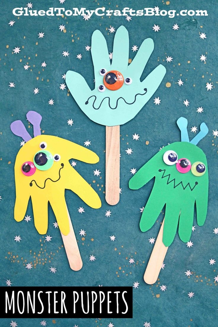 three hand puppets made to look like monsters