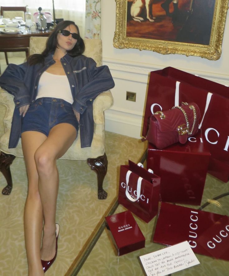 a woman sitting in a chair next to bags