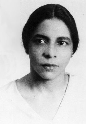 an old black and white photo of a woman with eyes wide open, looking at the camera