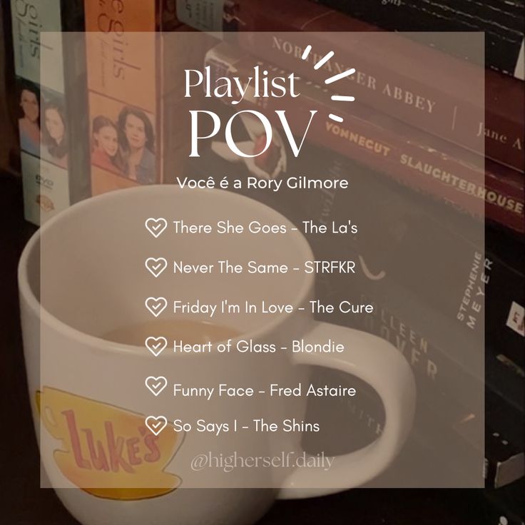 a coffee cup with the words playlist pov on it next to some books