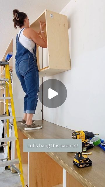 a woman standing on top of a wooden shelf