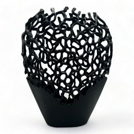 a black vase that is shaped like a heart with holes in the top and sides