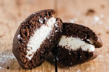 an oreo cookie is cut in half on a wooden table