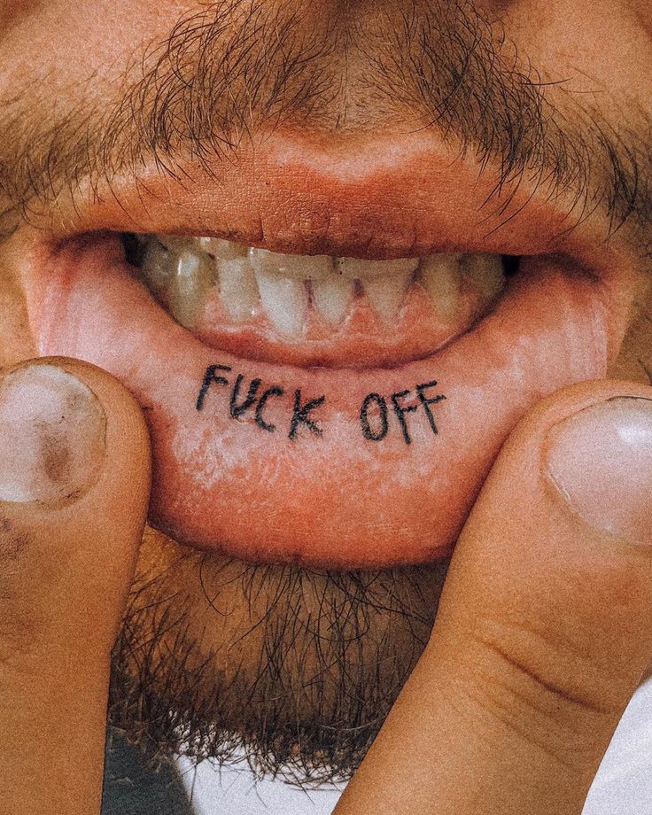 a man holding his nose with the word flick off written on it in front of his mouth