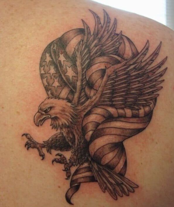 an eagle tattoo on the back of a woman's upper arm, with american flag in the background