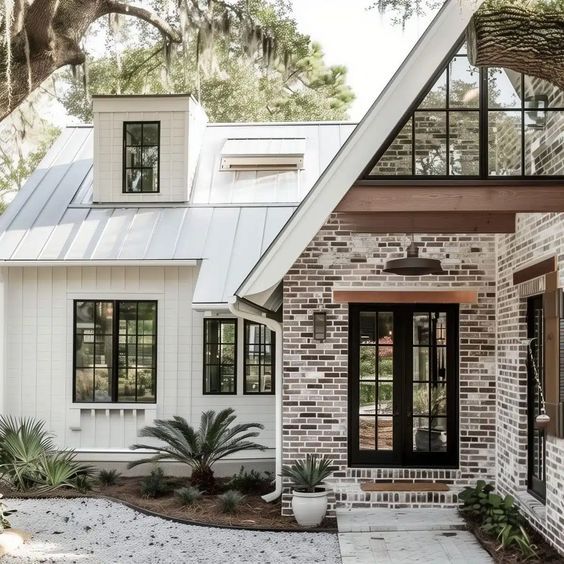 a brick house with white trim and black windows