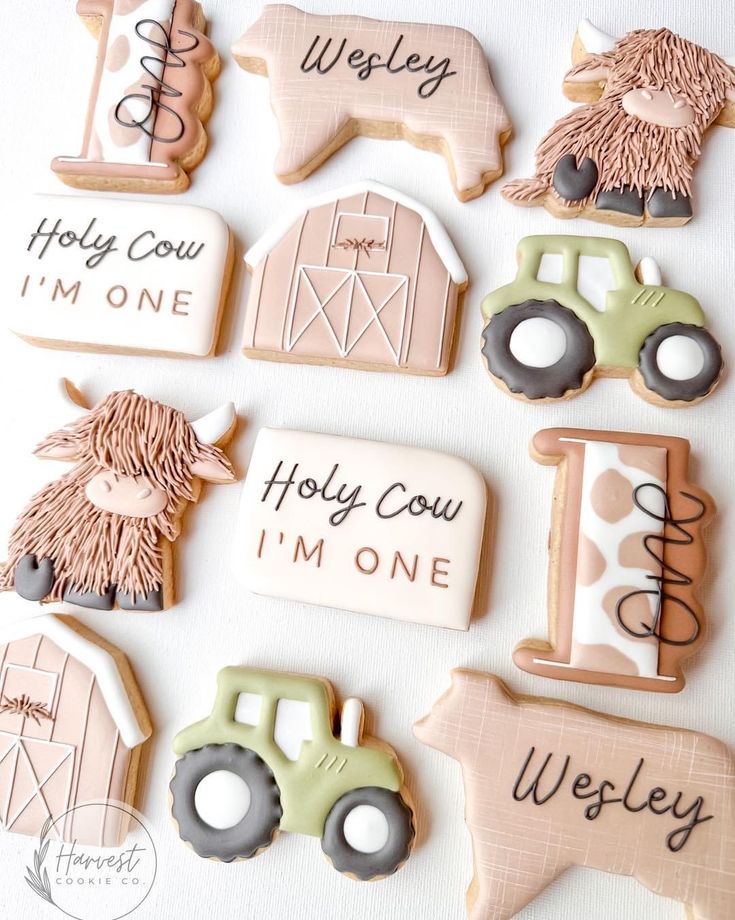 decorated cookies with farm animals and words on them are arranged in the shape of tractors