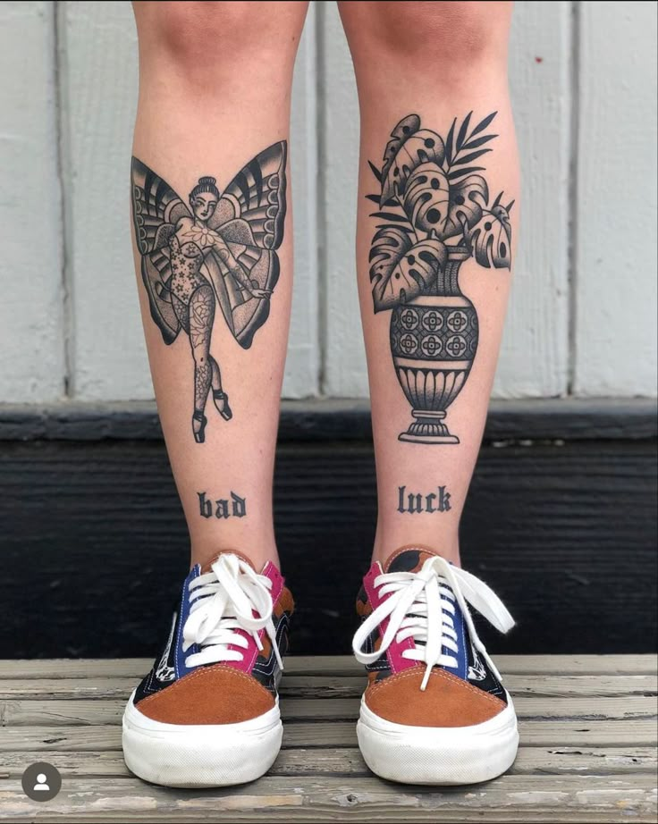 a woman's legs with tattoos on them and flowers in a vase behind her