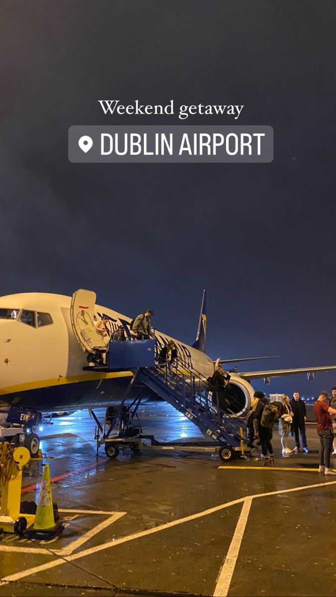 an airplane is parked on the tarmac with people standing around it, and there is a sign that says weekend getaway dublin airport