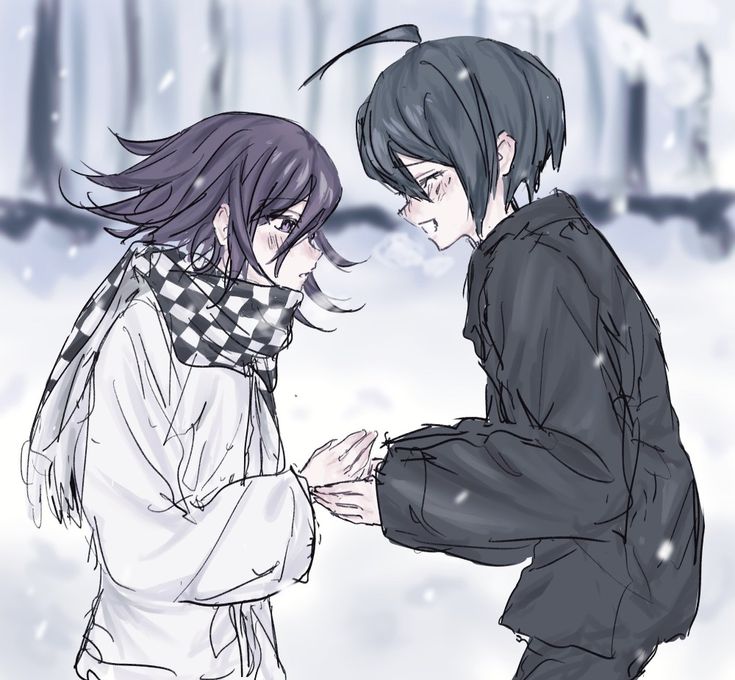 two people standing in the snow with one holding his hand out to another person's face