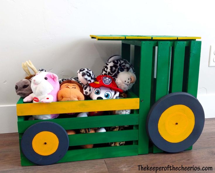 a wooden crate with stuffed animals in it