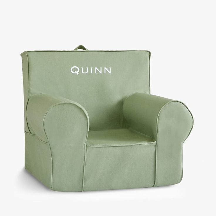 a green children's chair with the name quinn on it