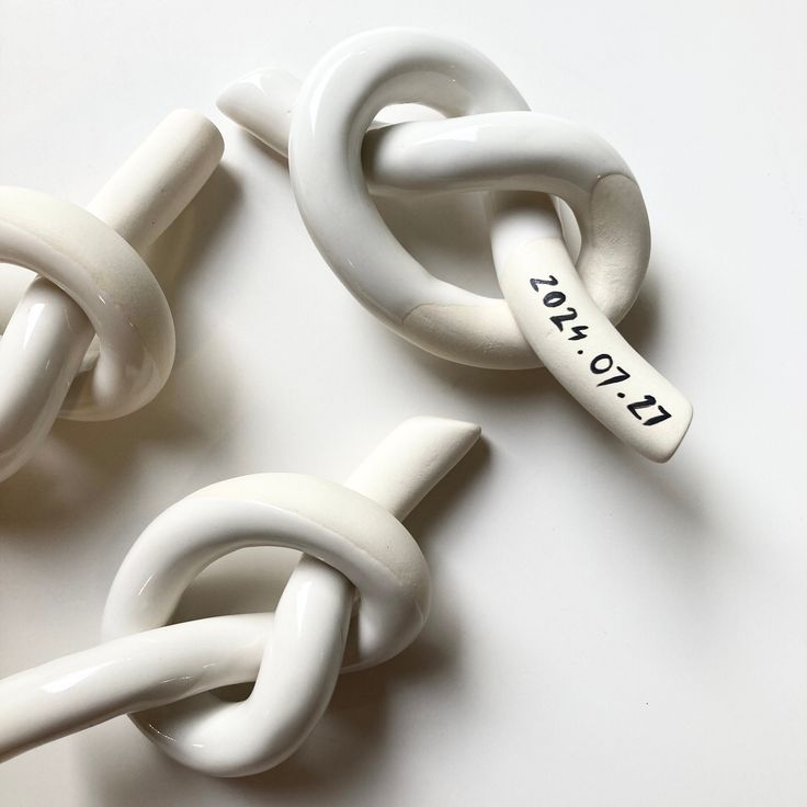 three white links with the words i love you written on one end and two smaller ones attached to each other