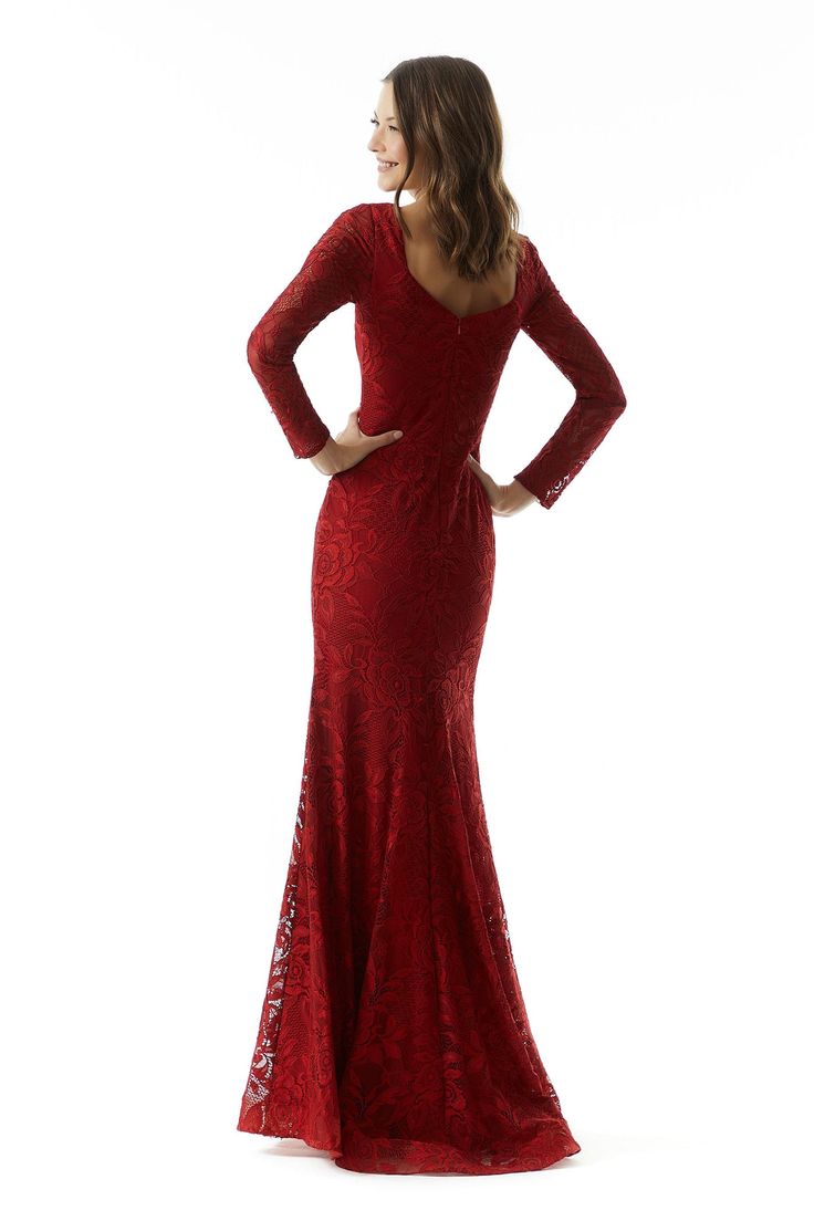 a woman in a long red dress with her hands on her hips, looking back