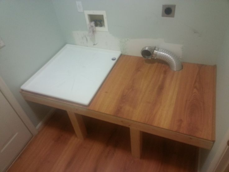 a bathroom with a sink and wooden counter top