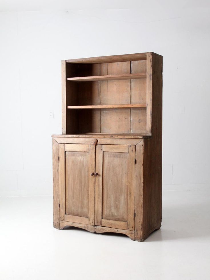 an old wooden cabinet sitting on top of a white floor