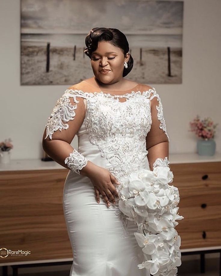 a woman in a wedding dress holding flowers