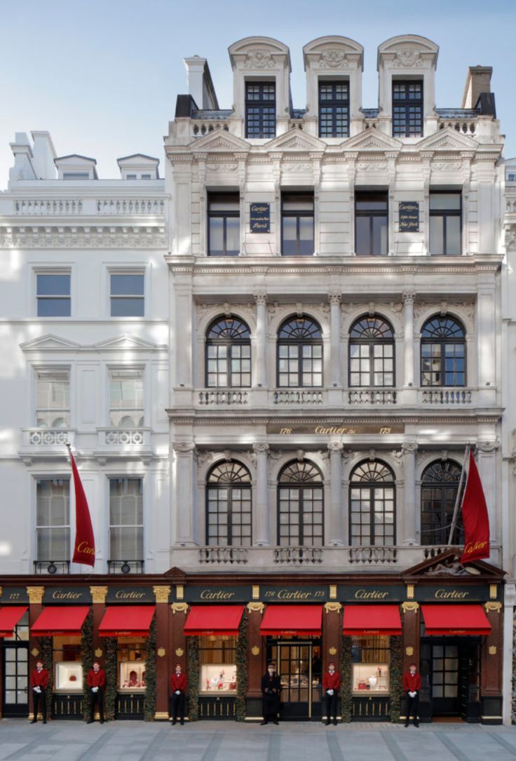 an old building with red awnings in front of it