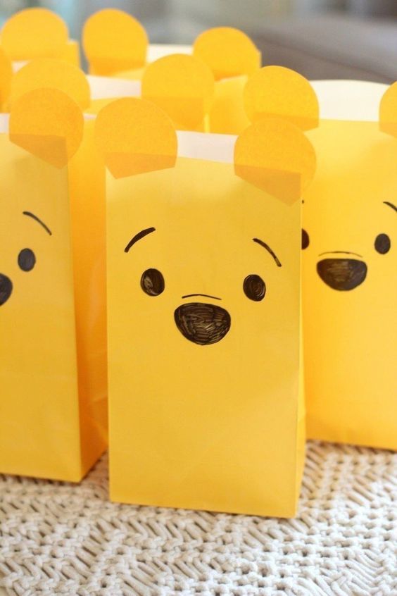 some yellow paper bags with faces on them