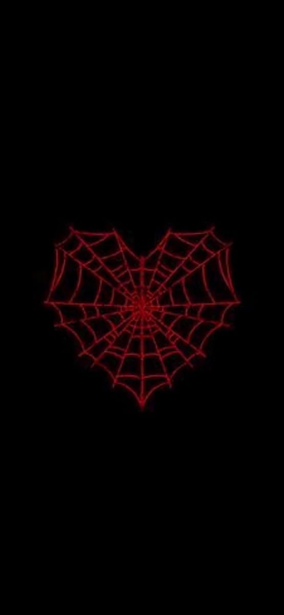 a red spider web on a black background