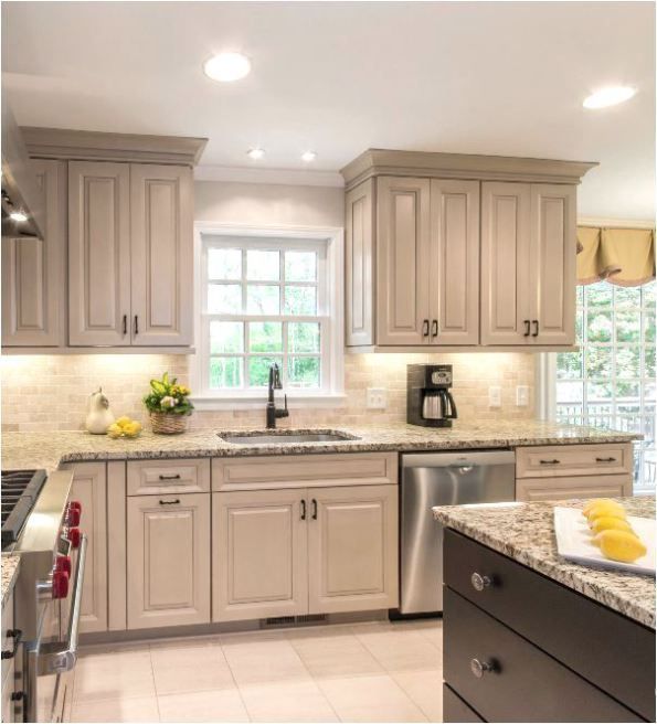 a kitchen with white cabinets and granite counter tops